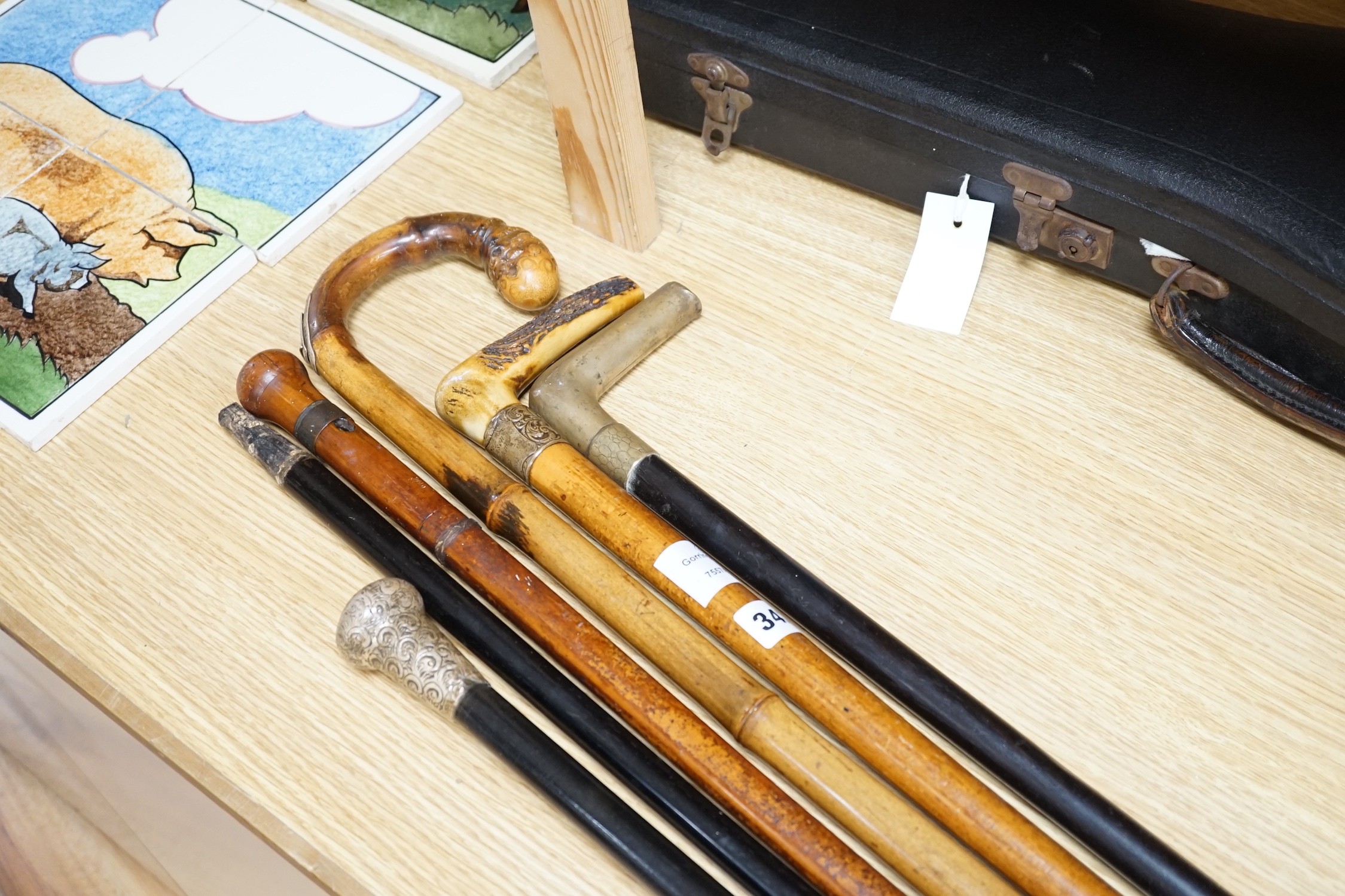 Two Victorian silver mounted walking sticks, a sword stick and three other sticks (6)